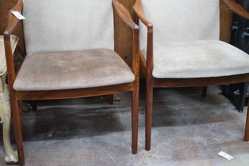 A pair of mid century teak upholstered elbow chairs, width 54cm, depth 63cm, height 84cm